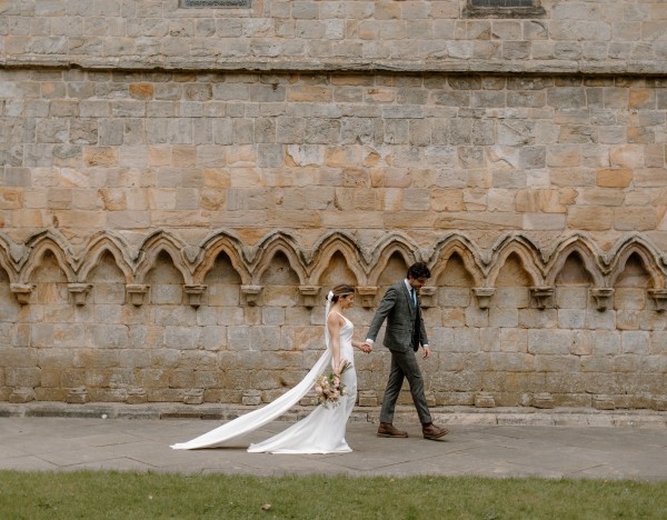 Bride and groom walking around the Brinkburn estate
