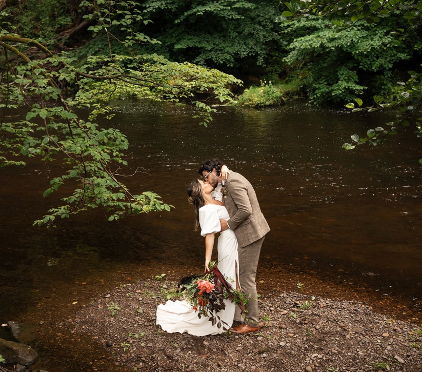 couple on the riverside at Brinkburn Northumberland