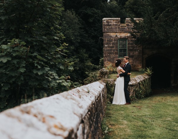 Lovely romantic couple hugging in front of historical building