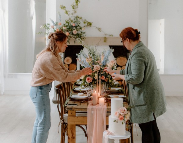 Two team members setting a dining table
