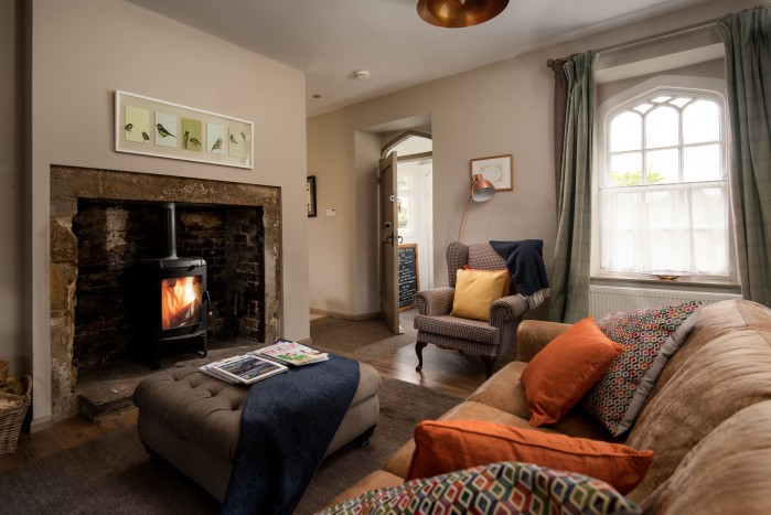cosy lounge with log burning fire in a cottage perfect for a small family