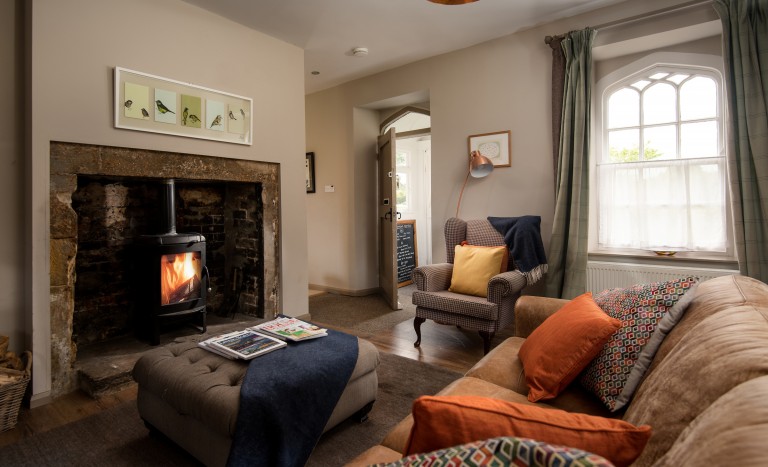 cosy lounge with log burning fire in a cottage perfect for a small family
