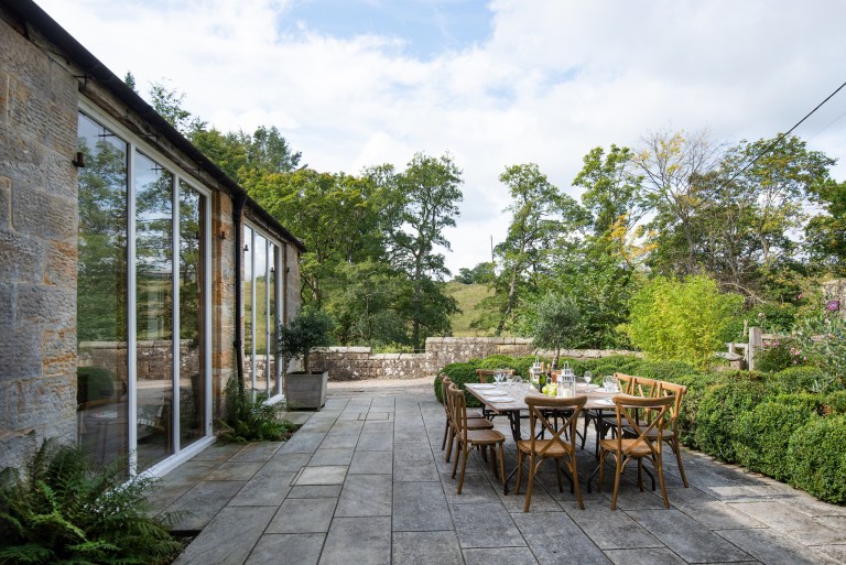 Intimate wedding meal outside surrounded by woodland