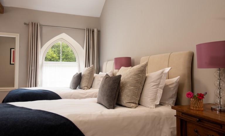 Twin beds in holiday cottage with woodland views of Brinkburn Priory in Northumberland