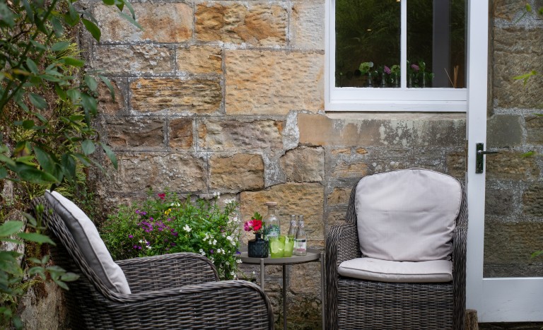 relaxing retreat in Northumberland with rattan furniture outside cottage for two