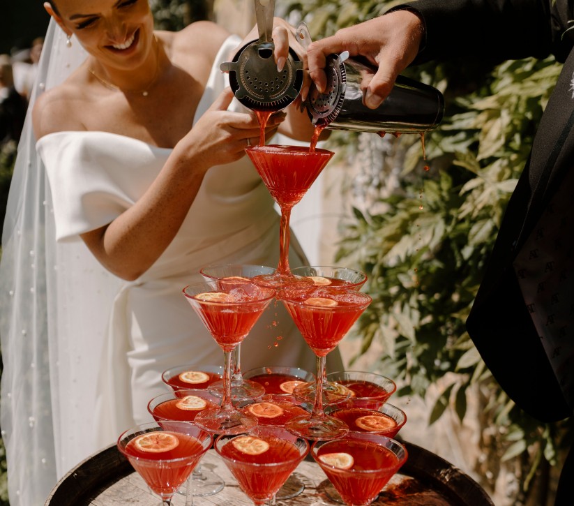 bride pouring a cocktail drinks tower at Brinkburn Northumberland