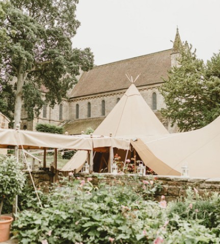 A large wedding tipi inside a large garden