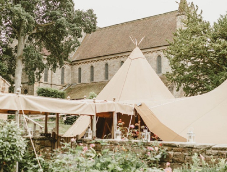 A large wedding tipi inside a large garden