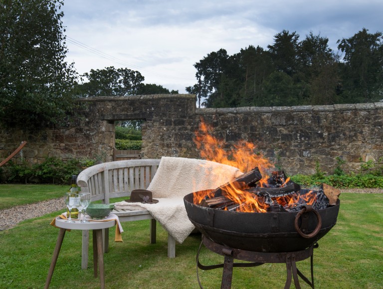 fire pit and bench outside holiday cottage at Brinkburn Northumberland