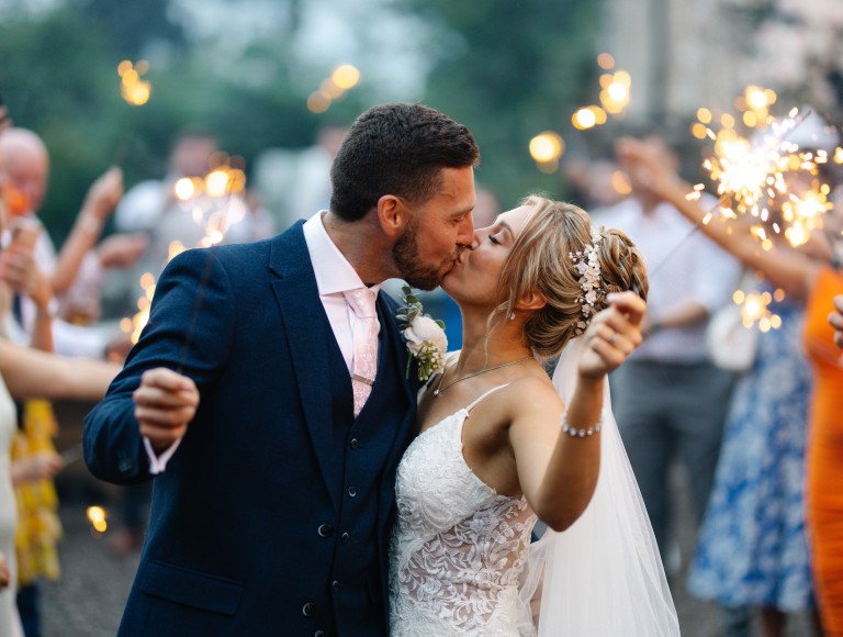 couple with sparklers getting married at Brinkburn Northumberland