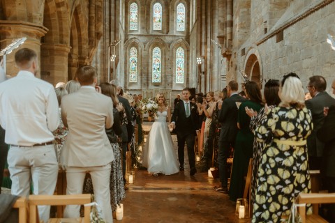 The tipi external in front of Brinkburn Priory on a wedding day