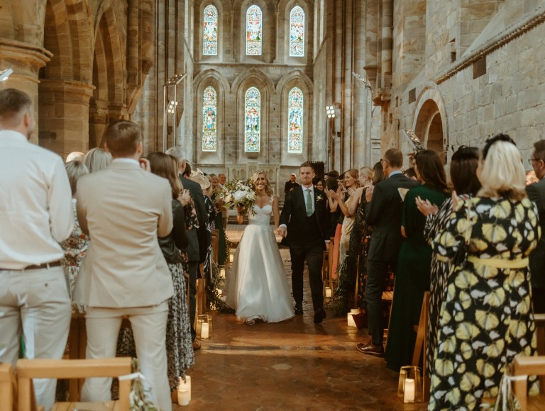 The tipi external in front of Brinkburn Priory on a wedding day