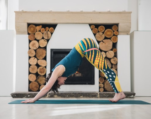 yoga teacher doing downward dog pose at a yoga class at Brinkburn Northumberland
