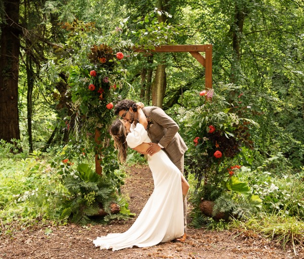 couple kissing at the riverside elopement location at Brinkburn Northumberland
