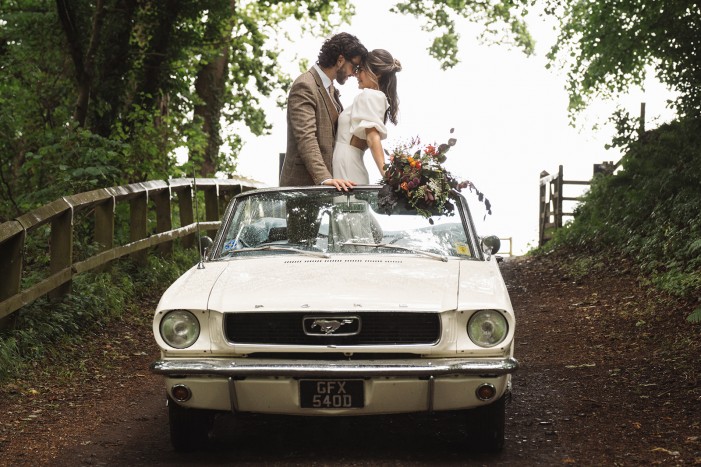 couple in classic car leaving elopement ceremony at Brinkburn Northumberland