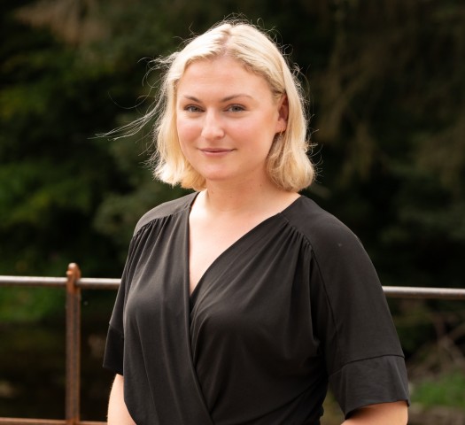 Portrait shot of Harriet wearing a white top