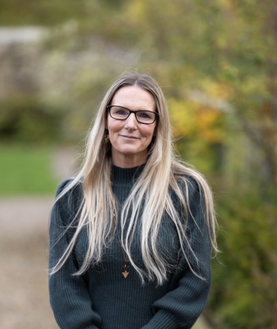 Portrait shot of Katy wearing a dark top