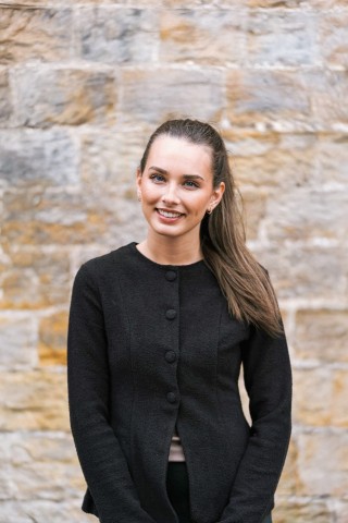 Portrait shot of Lucie wearing a black jacket and black top