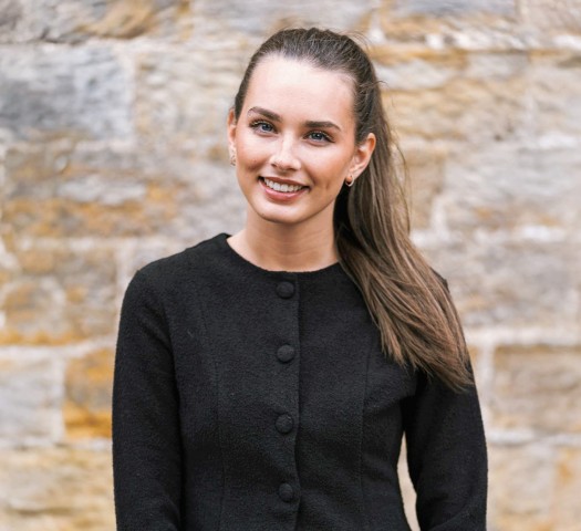 Portrait shot of Lucie wearing a black jacket and black top