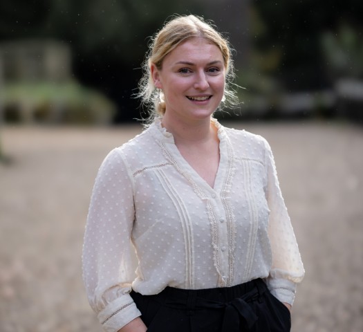 Portrait shot of Harriet wearing a white top