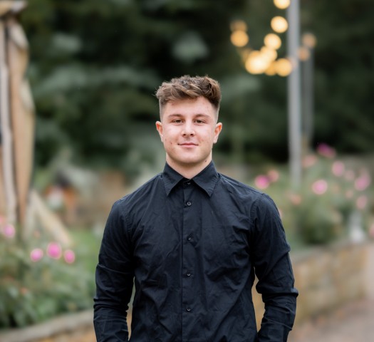 Portrait shot of James wearing a black shirt