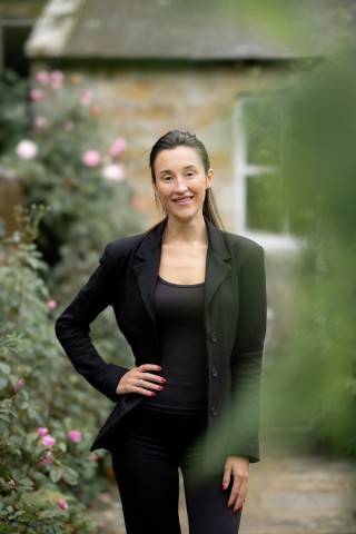 Portrait shot of Jess wearing a black jacket and black top