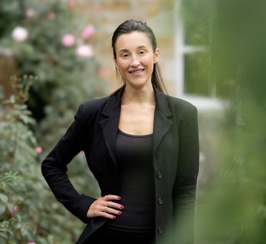 Portrait shot of Jess wearing a black jacket and black top