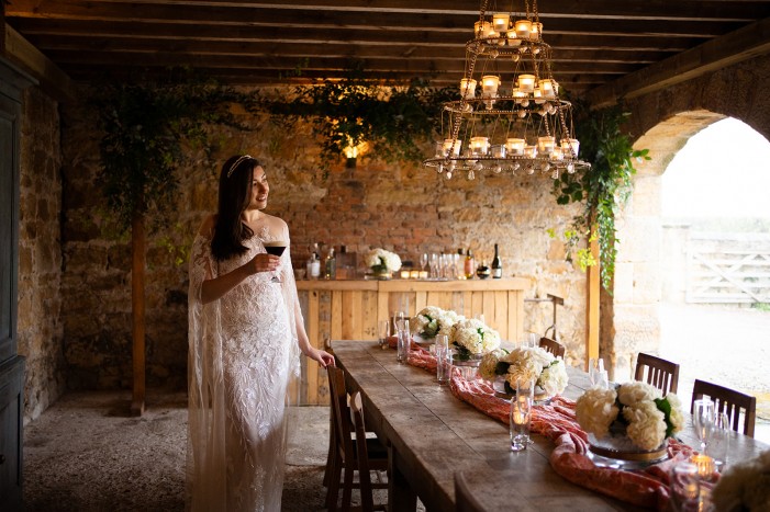 bride under the arches at Brinkburn Barn