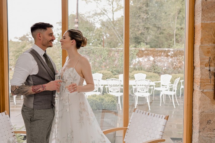 brigand groom in the stables after an intimate garden room wedding at Brinkburn Northumberland
