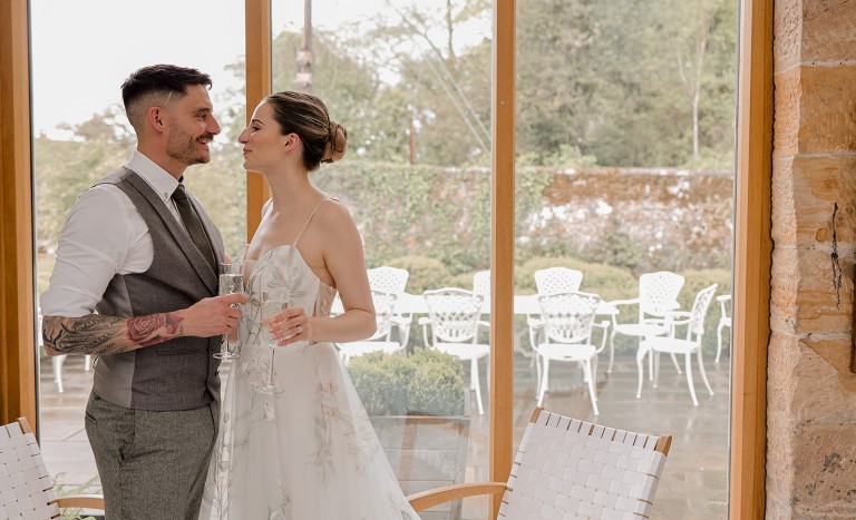 brigand groom in the stables after an intimate garden room wedding at Brinkburn Northumberland