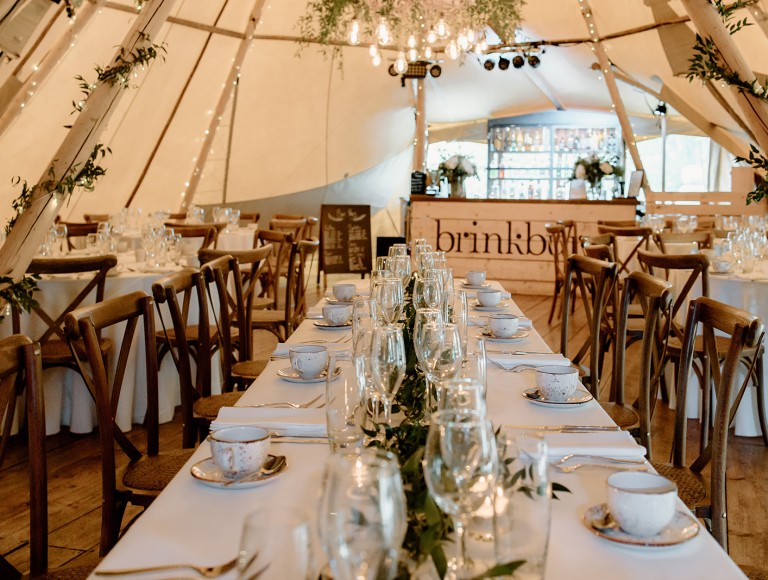 The tipi with brown chairs set for a wedding day at Brinkburn Northumberland