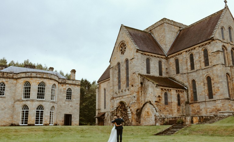 bride and groom outside the priory and Manor House at Brinkburn Northumberland wedding