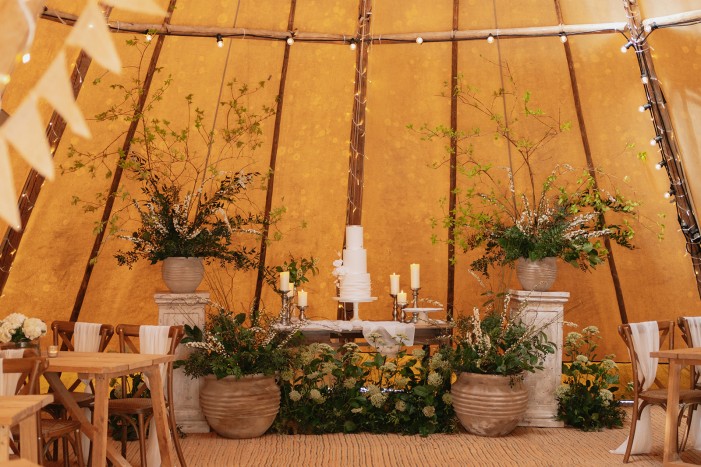 wedding cake and florals in tipi