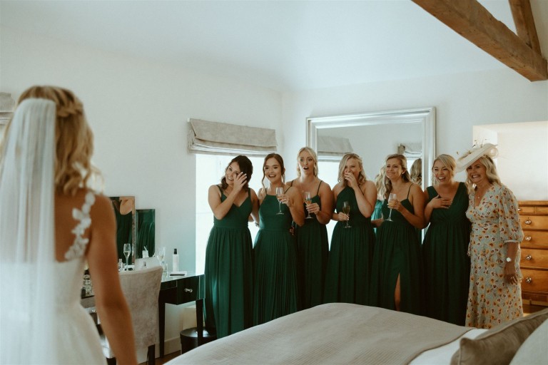 Bride wedding dress reveal to bridesmaids before ceremony