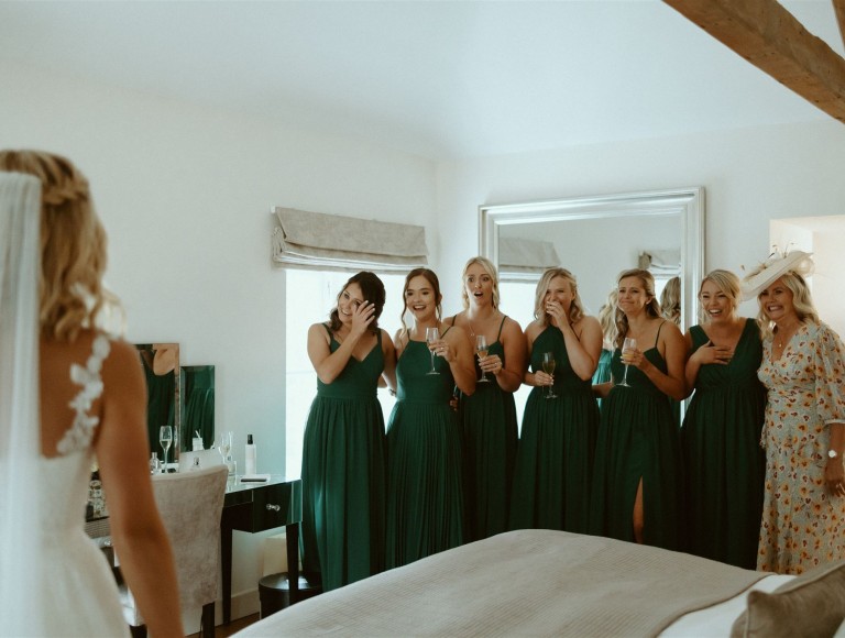 Bride wedding dress reveal to bridesmaids before ceremony